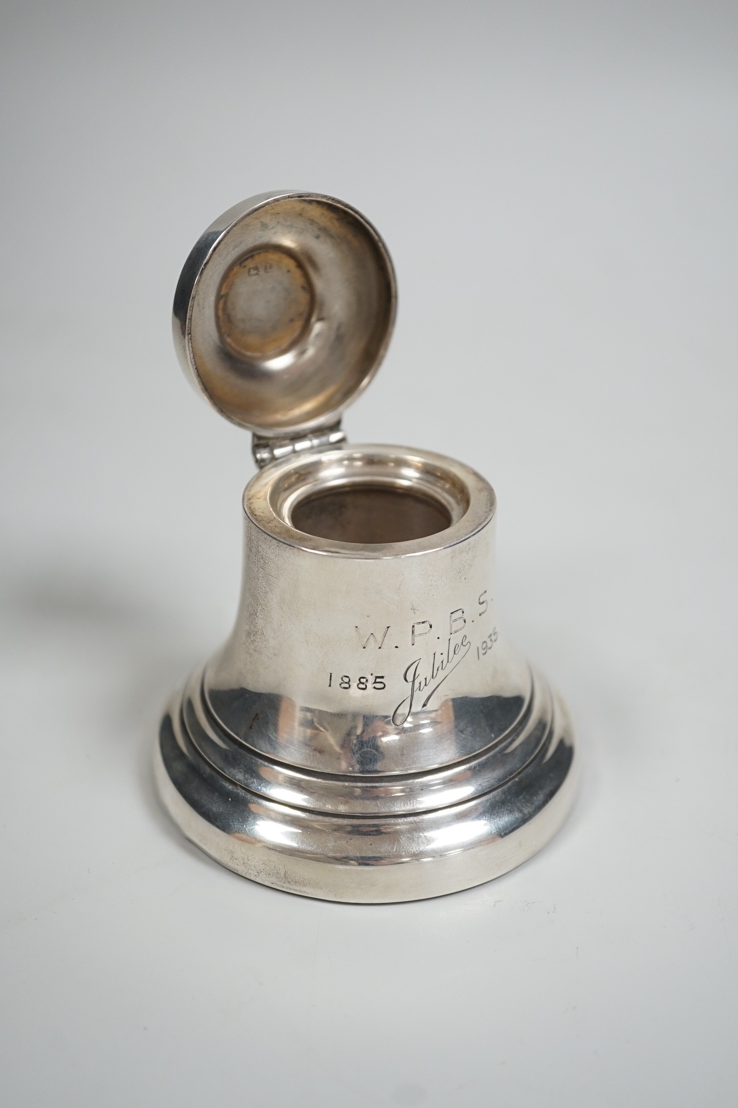 A George V silver mounted inkwell, modelled as a bell, Birmingham, 1935, height 97mm.